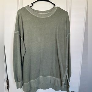 Sage green long sweatshirt with side slits at hips
